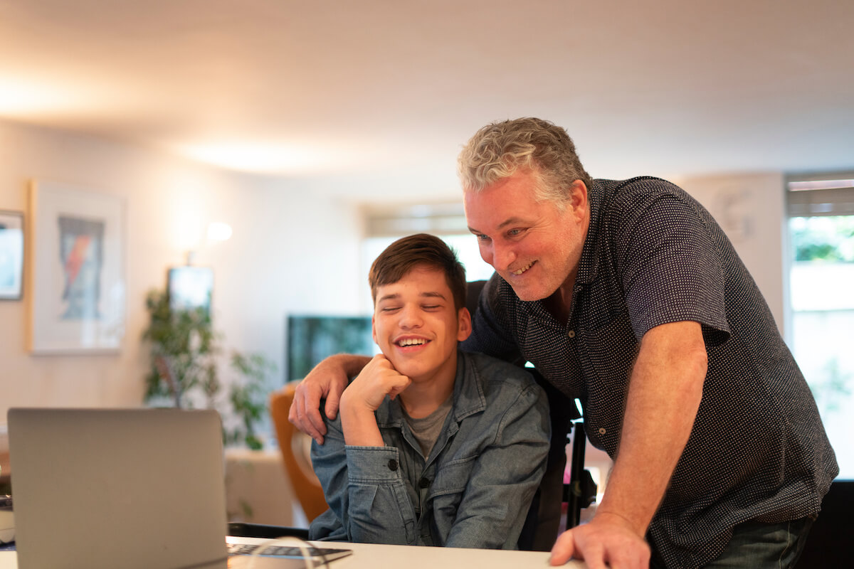 6545492ca7b7108809168578_father-son-disability-computer-laugh